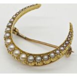 A yellow metal brooch in the form of a crescent set with graduated seed pearls together with a bar