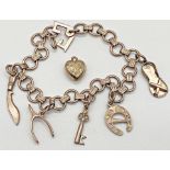 9ct gold charm bracelet with seven charms (one loose) 17 cm long approx. Weight 14.61 approx.