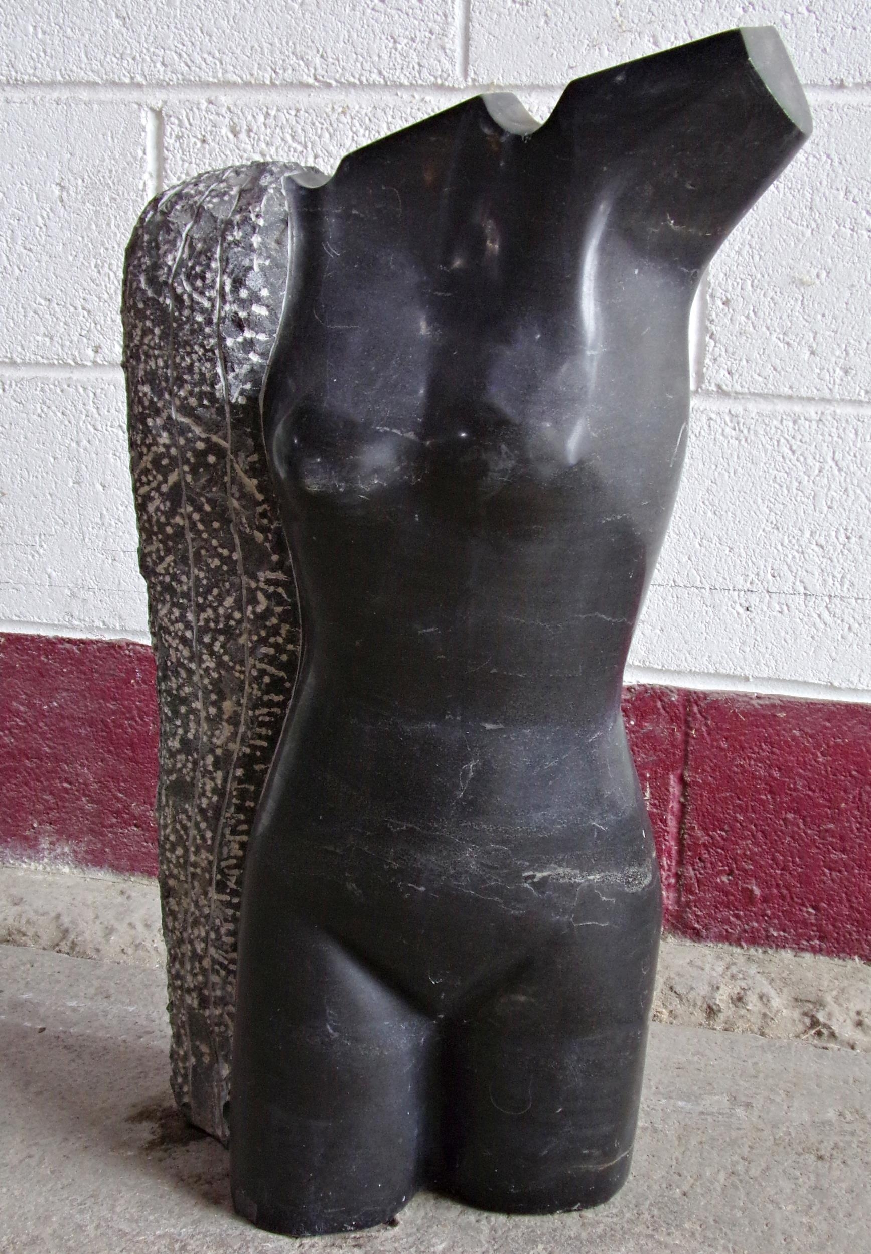 Well carved black marble nude torso, 70cm high