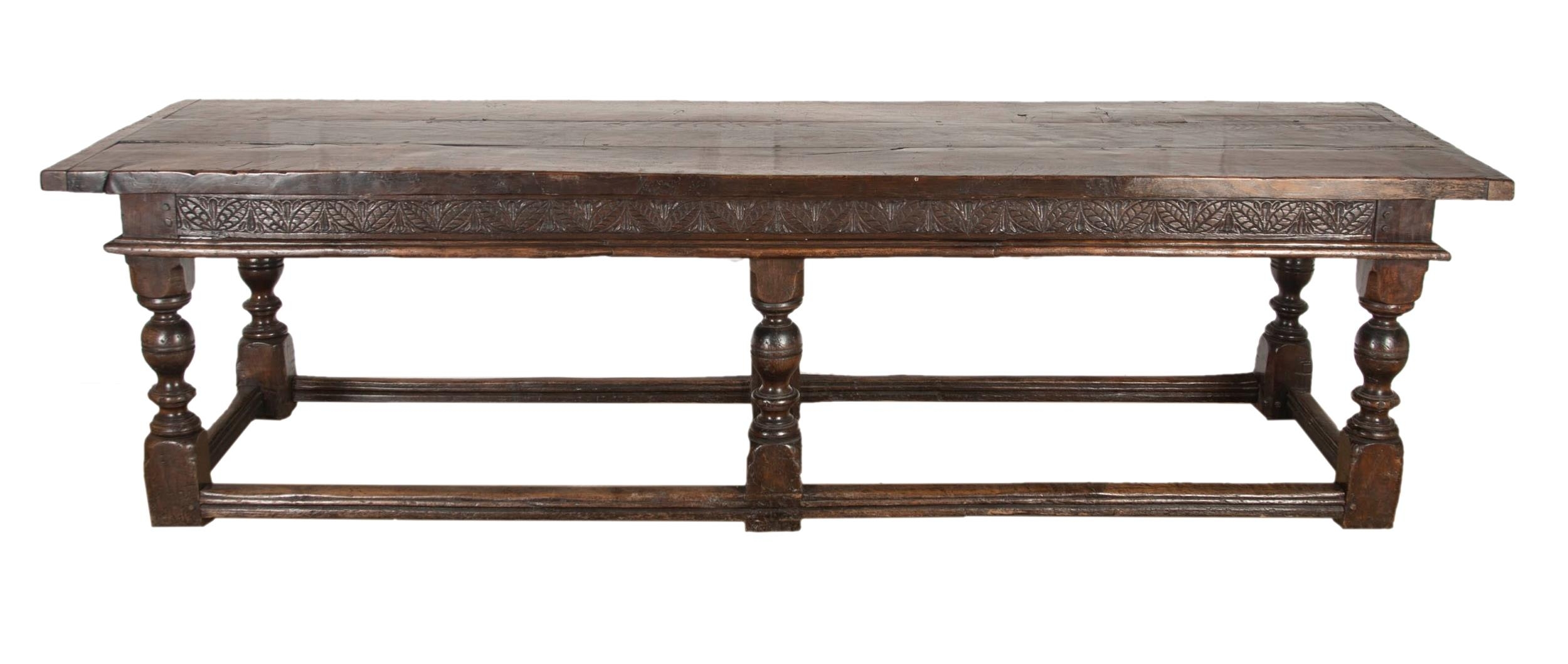 Impressive 17th century style refectory table, thick oak top over a carved floral frieze and six