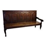 18th century oak five panel back settle, carved floral decoration, later elm seat, cabriole front