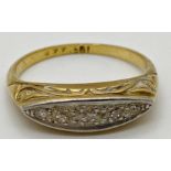 18ct gold ring with scrolling decoration to the mount set with 5 small graduated Diamonds Size M 1/2
