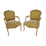 Pair of 19th century French fauteuil salon chairs, painted frames with gilt highlights, studded