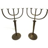 Monumental pair of gilt copper menorah style floor standing altar candlesticks, with hammered finish