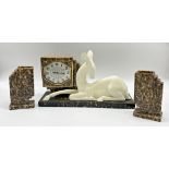 Art Deco ceramic figural clock garniture, with recumbent deer, octagonal silvered dial and two