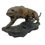 French cast spelter figure of a leopard, signed T Cartier, with glass eyes, 63cm long x 33cm high