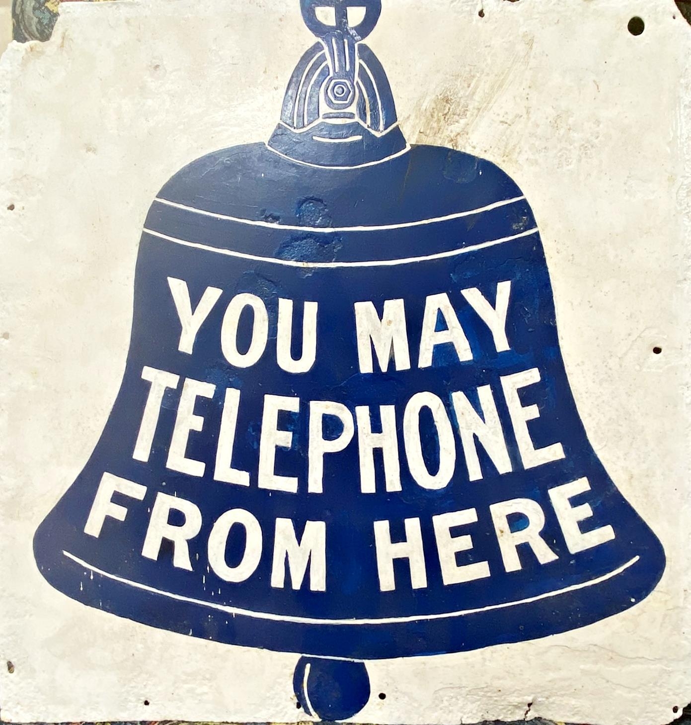 Vintage aluminium advertising sign decorated with a bell and inscribed 'you may telephone from