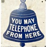 Vintage aluminium advertising sign decorated with a bell and inscribed 'you may telephone from