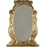 Good Arts & Crafts embossed brass wall mirror, oval bevelled plate flanked by scrolled fish with