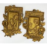 Pair of Austrian gilt pottery panels, decorated in relief with a girl eating cherries and a girl