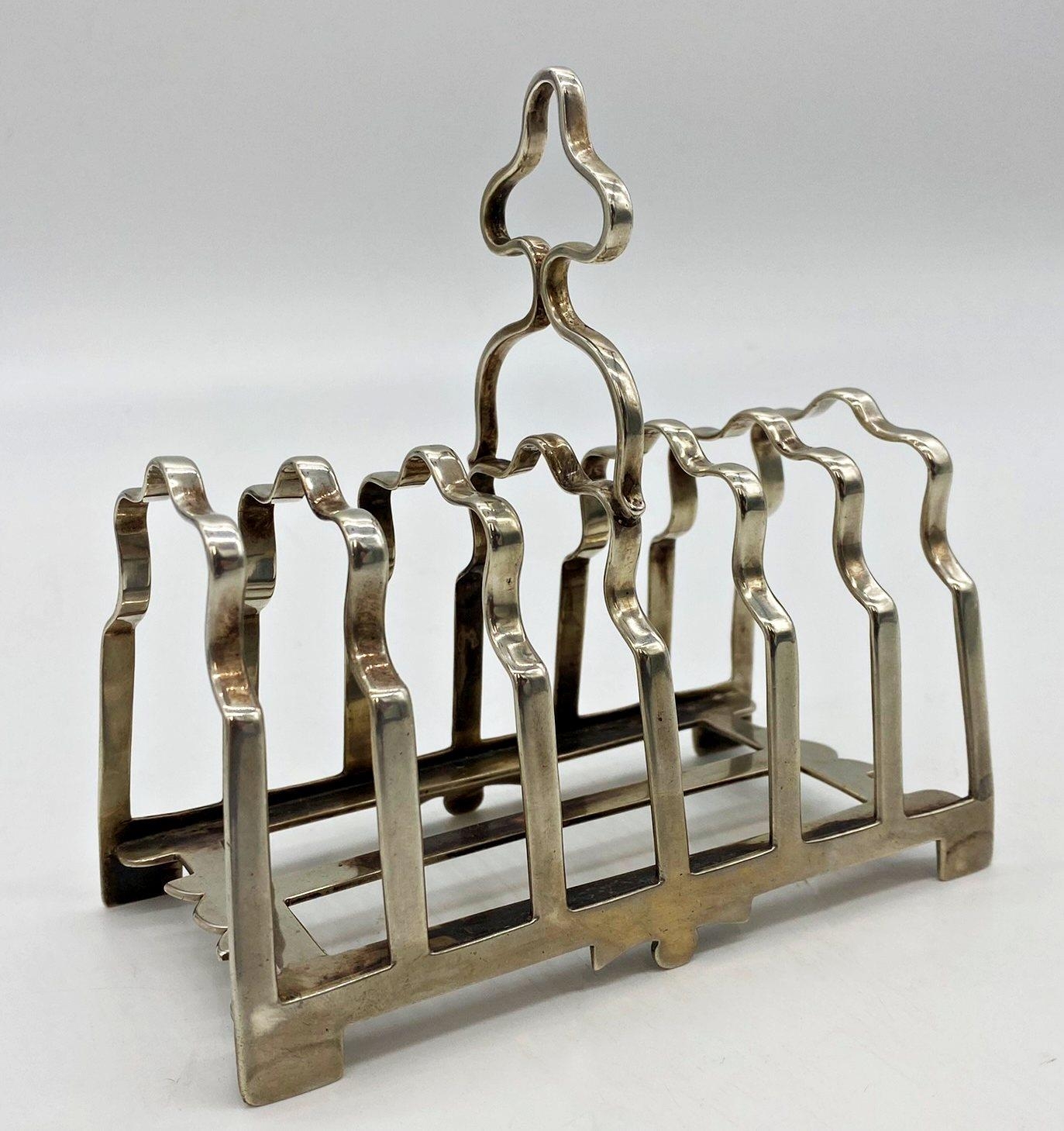 Good quality early 20th century cast silver six divisional toast rack, maker James Dixon & Sons,