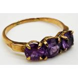 14ct gold ring set with 3 graduated Amethyst stones. Size S, weight 2.6 grams approx.