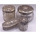 Four silver topped cut glass dressing jars