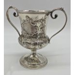 Georgian white metal twin handled cup, with later Victorian chasing, no hallmarks present, 17cm