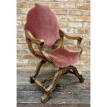 A continental Savonarola throne chair, with studded pink velvet upholstery and good fluted moulded