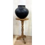 Unusually large African clay pot upon a good turned softwood tripod stand