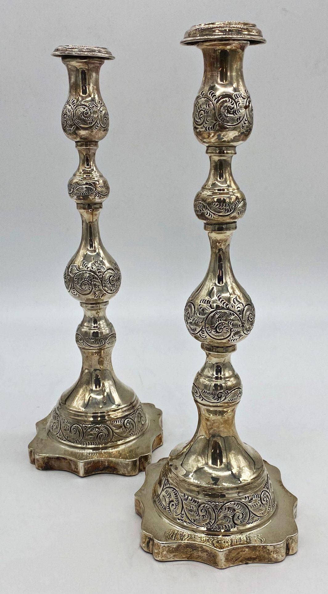 A pair of George V silver Sabbath candlesticks, with knopped stems, raised on a shaped platform