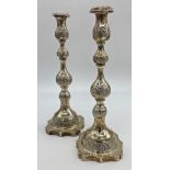 A pair of George V silver Sabbath candlesticks, with knopped stems, raised on a shaped platform