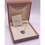 Clogau pendant on a fine chain in the form of a heart with a central rose. Housed within the