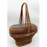 Japanese ikebana type basket with woven decoration and centrally fitted with a lacquered panel,