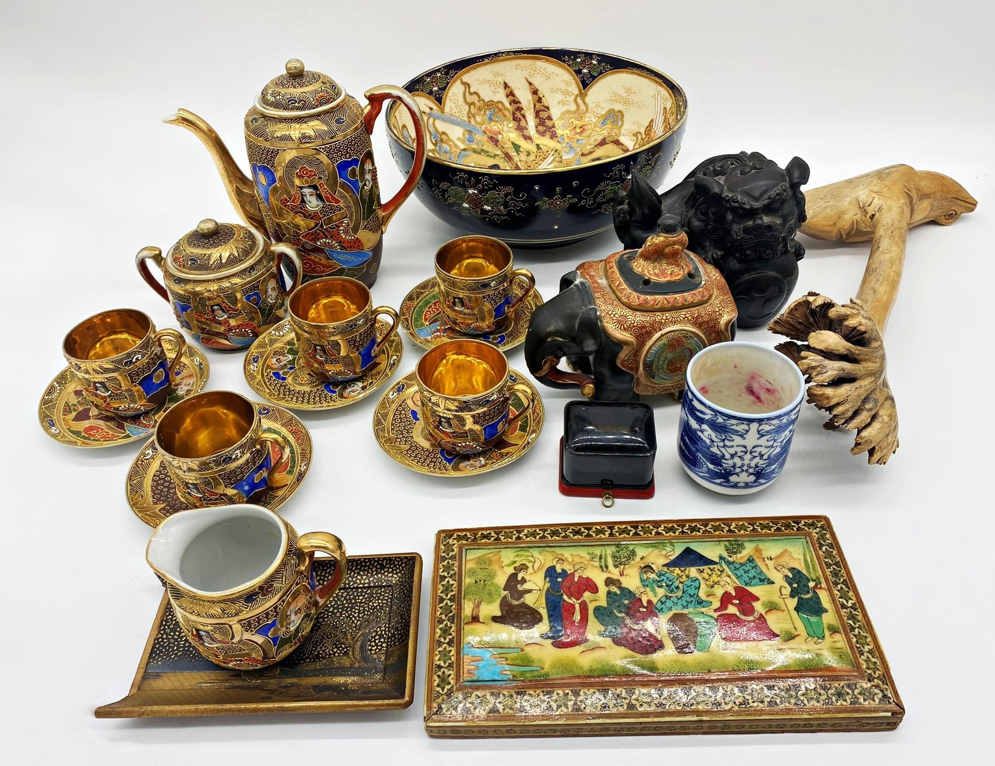 A mixed collection of oriental items to include a satsuma tea service, a carved wooden dog of Fo,