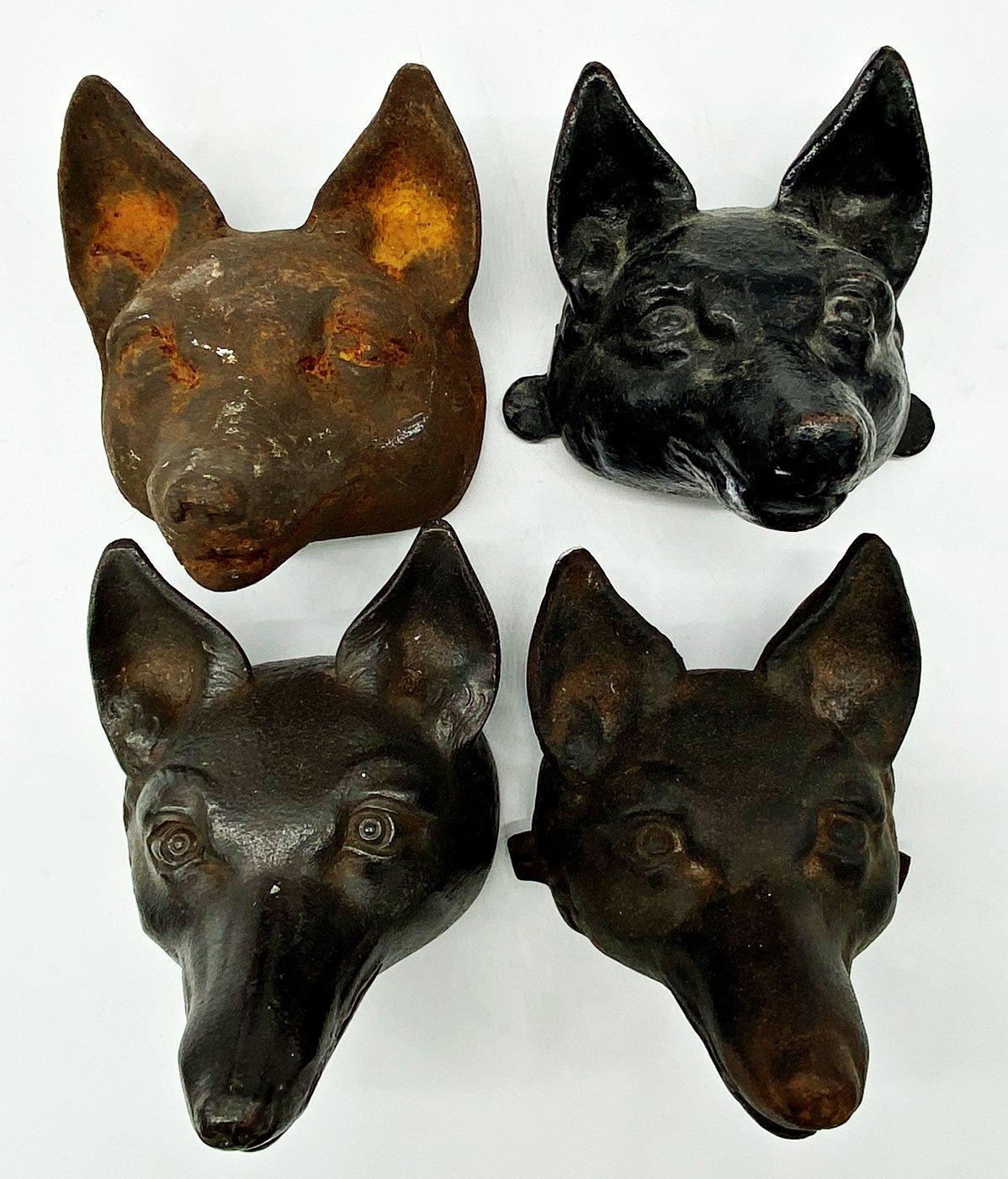 Set of four cast iron fox heads, possibly wall mounts, each 15cm high x 15cm deep (4)