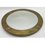 Arts & Crafts brass framed circular mirror with bevelled glass plate, the frame work with applied