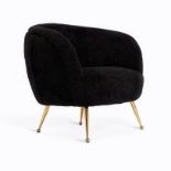Cool black sheepskin lounge chair on brass tapered legs