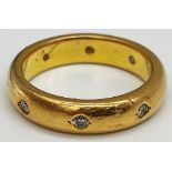 18ct gold band set with 8 interspaced Diamonds. Weight 10.8 grams approx.