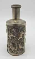 Indian white metal bottle sleeve, with screw top and hinged base, decorated with various wildlife,