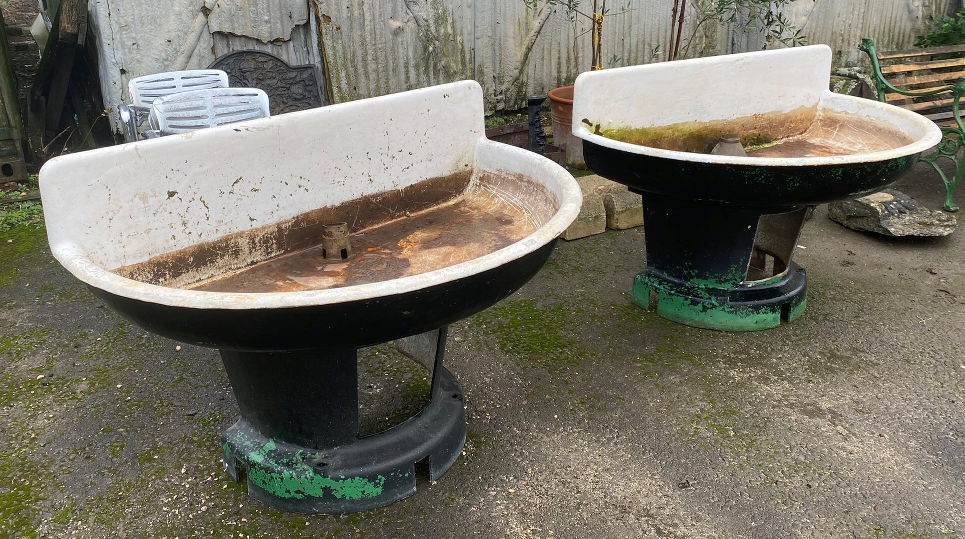 Quite remarkable pair of large enamelled feeders or troughs or sinks, d-end form on tapered bases,