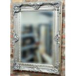 Decorative silver framed wall mirror with rococo motifs and bevelled glass plate, 120cm x 86cm