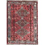 Afghan three medallion rug, red ground, 165 x 105cm