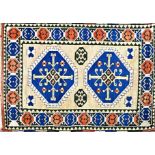 Turkish mid pile rug, two blue medallions on a washed ground, 195 x 130cm