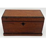 Regency mahogany sarcophagus tea caddy with fluted rims, the hinged lid enclosing a twin lidded