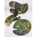 Three large artist's palettes with various paint traces, the largest 62cm long (3)