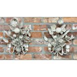 A pair of 19th century French enamelled twin branch wall lights amidst scrolled bouquets of foliage,
