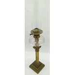 An old brass Corinthian column oil lamp with geometric cut glass reservoir, 74cm including flue