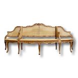 Good French carved wood and Bergere cane conversation sofa, 260cm wide x 100 high x 75 deep