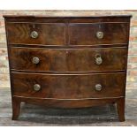 Georgian mahogany bow fronted chest of drawers, two short over two long with the escutcheon embossed