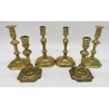 Three pairs of Queen Anne period brass candlesticks, two pairs with octagonal bases, the largest