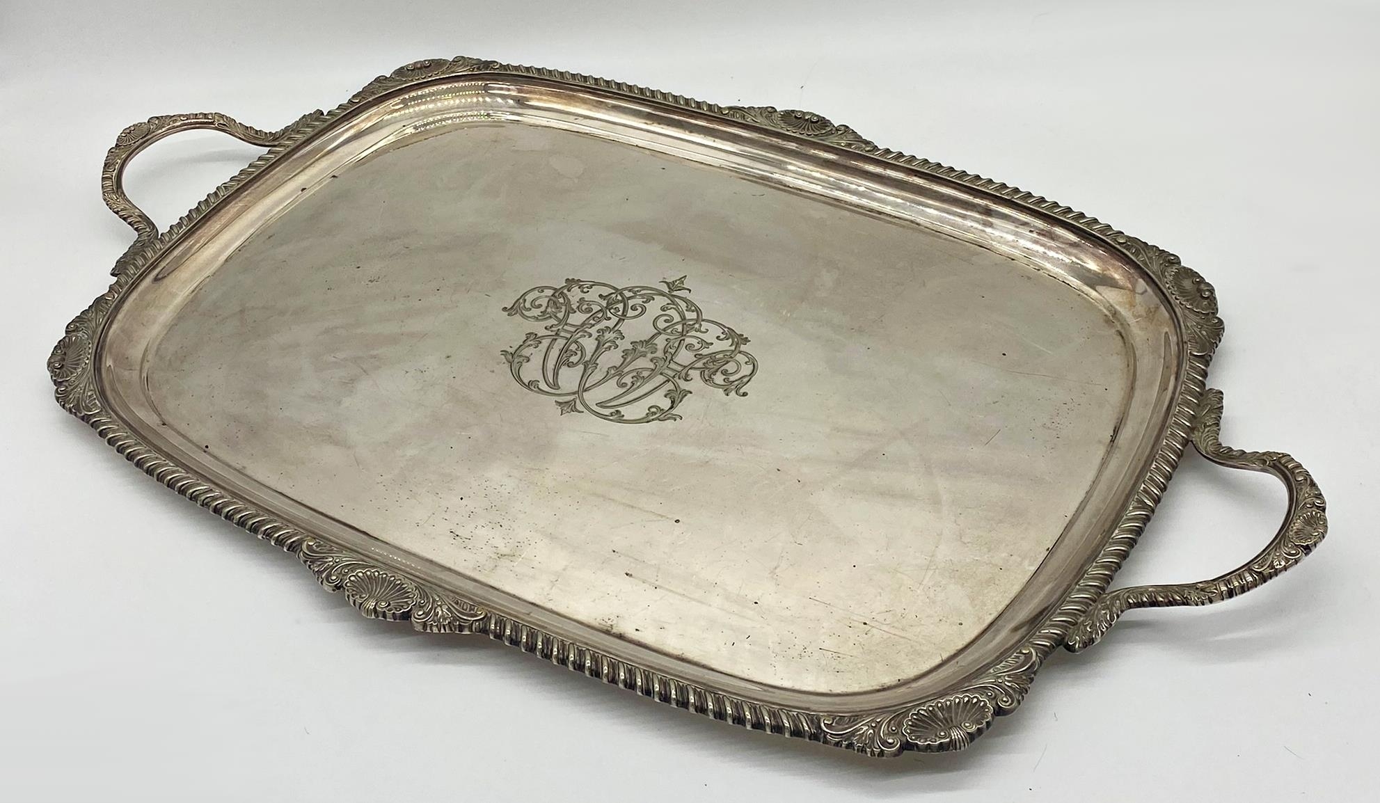 Very large silver plated twin handled tray, with cast scallop shell boarders, by Walker & Hall, 76cm