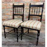 A pair of Aesthetic movement ebonised salon chairs, with stuffover candy stripe upholstered seats