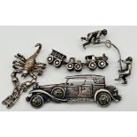 A sterling silver charm consisting of a steam train with two carriages, articulated for movement