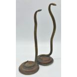 Good pair of antique brass serpents standing at full height on their tails upon stepped circular
