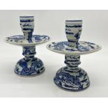 Pair of Chinese blue and white Kangxi style candle sticks, the oversized drip trays decorated coiled