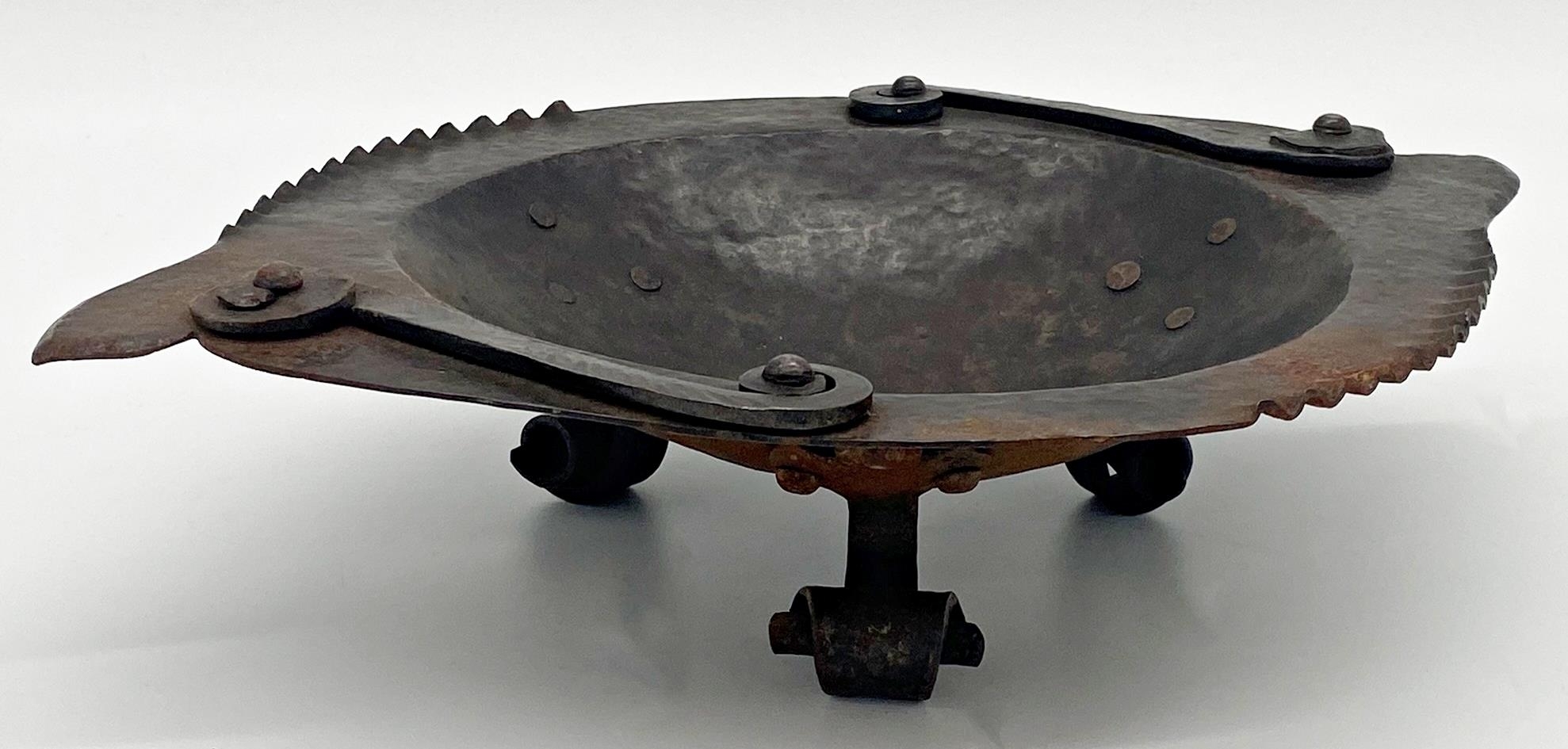 Unusual Arts & Crafts iron dish with applied scroll work and scrolled feet, 7.5cm high x 34cm long