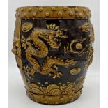 Early 20th century Chinese pottery barrel stool decorated in relief with pearl chasing coiled