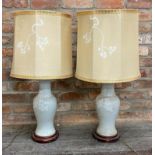 Pair of Chinese celadon porcelain baluster table lamps with typical white overlay decoration with