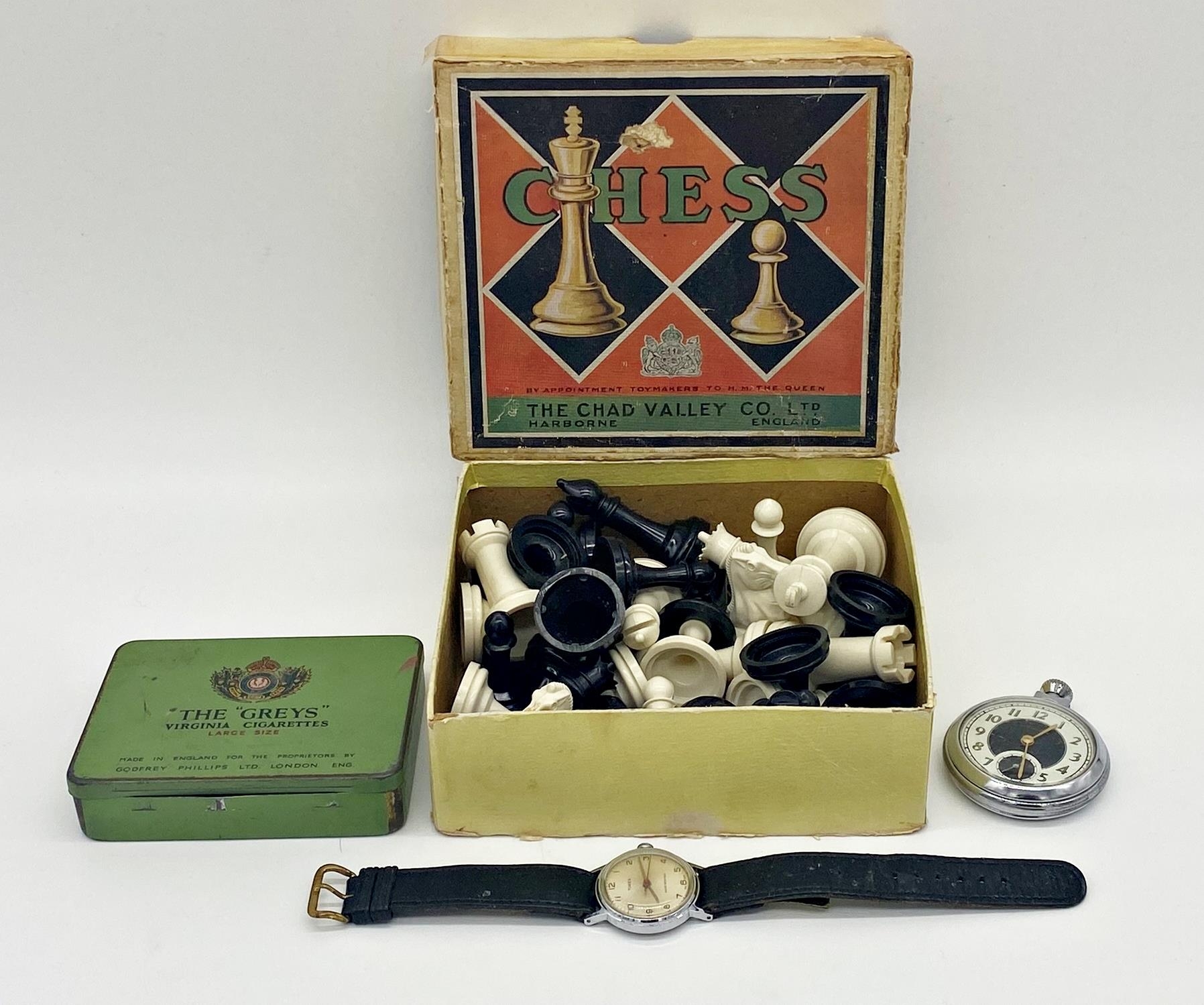 Mixed cabinet lot to include a vintage chrome Ingersoll pocket watch, Timex wristwatch, a Chad